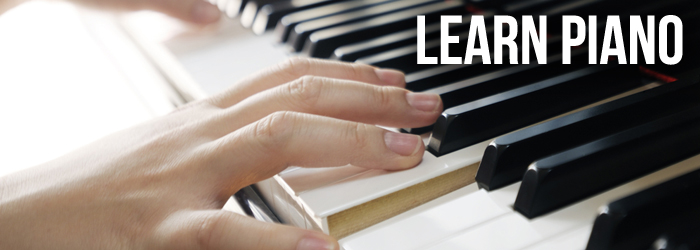 Close up view of hands playing a piano